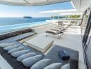 Luxurious outdoor patio overlooking the ocean with seating and sunshade