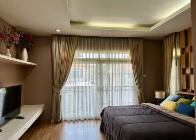 Elegant and cozy bedroom with modern furnishings and ample natural light