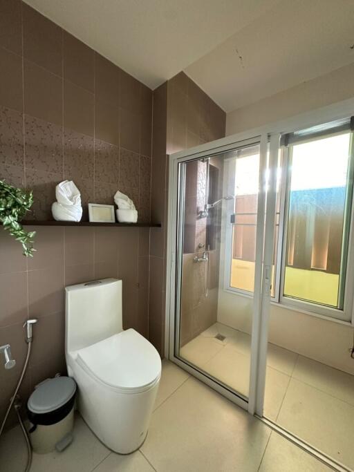Modern bathroom with walk-in shower and decorative shelving