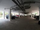 Spacious indoor parking garage with multiple cars and well-organized layout