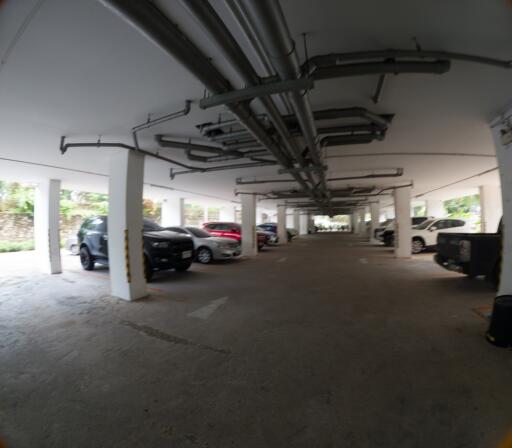 Spacious indoor parking garage with multiple cars and well-organized layout