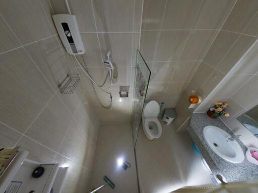 Spacious modern bathroom with wall-mounted fixtures and glass shower