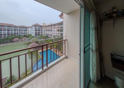Balcony view of a serene pool area with privacy screen