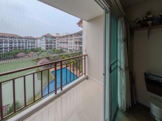 Balcony view of a serene pool area with privacy screen