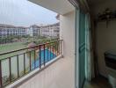 Balcony view of a serene pool area with privacy screen