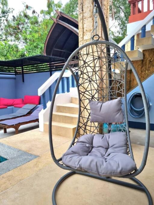 Cozy outdoor patio area with hanging swing chair and comfortable seating