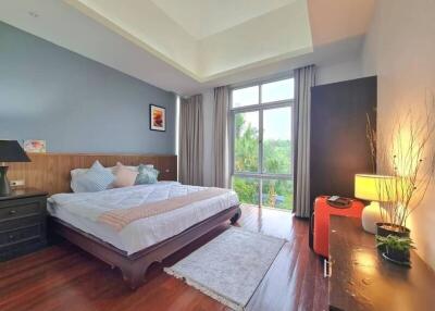 Spacious bedroom with natural light and serene view