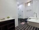 Modern and bright bathroom with stylish black and white tiling