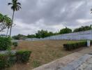 Spacious outdoor area with garden and high walls