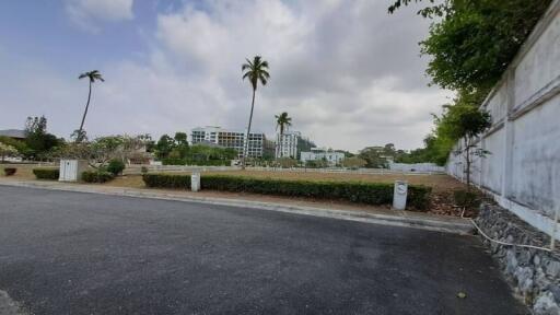 View of residential buildings and lush vegetation from a street