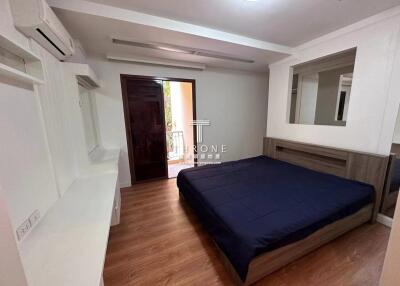 Spacious bedroom with modern amenities and wooden flooring