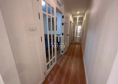 Bright hallway with wooden floors and glass paneled doors