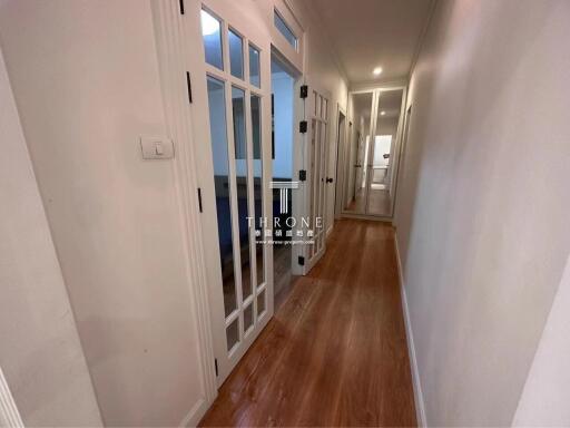 Bright hallway with wooden floors and glass paneled doors