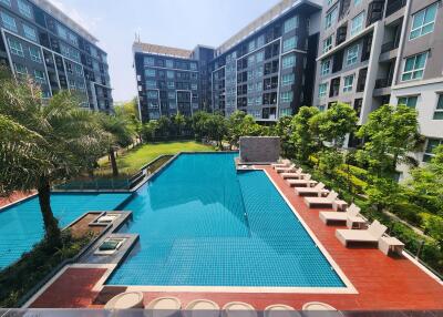 Outdoor swimming pool with lounging chairs in a residential apartment complex