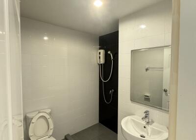 Modern bathroom interior with shower, toilet, and sink