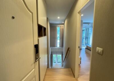 Spacious hallway leading to a well-lit room with a view of the balcony