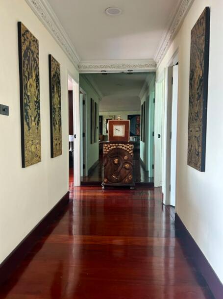 Elegant hallway with hardwood floors and decorative art