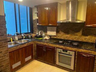 Modern kitchen with wooden cabinets and stainless steel appliances