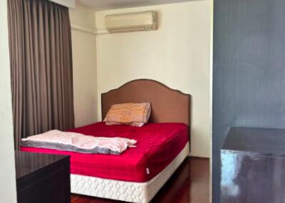 Cozy bedroom with wooden flooring and modern amenities
