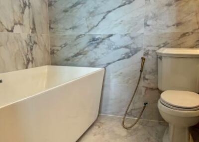 Modern bathroom with marble tiles and white fixtures