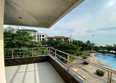 Spacious balcony overlooking the pool and ocean with a view of surrounding buildings