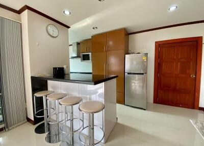 Modern kitchen with breakfast bar and stainless steel appliances