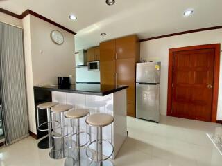 Modern kitchen with breakfast bar and stainless steel appliances