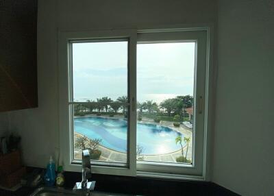 Kitchen window overviewing pool and ocean