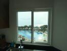 Kitchen window overviewing pool and ocean