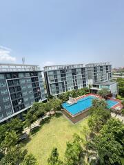 Aerial view of a modern residential complex with pool and garden