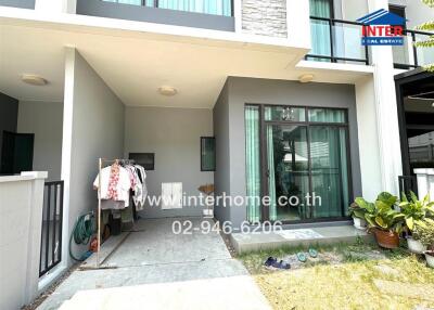 Modern home front with large glass windows and carport