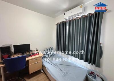 Compact and furnished bedroom with work desk and natural light
