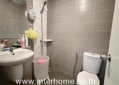 Modern bathroom interior with neutral tiled walls