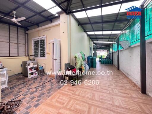 Spacious covered utility area in a residential building with tiled flooring