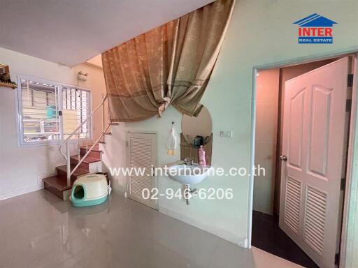 Bright and spacious living room with staircase and decorative elements