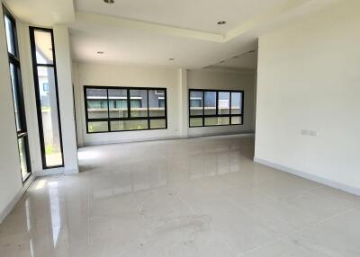 Spacious and brightly lit empty living room with large windows