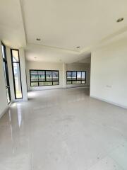 Spacious and brightly lit empty living room with large windows