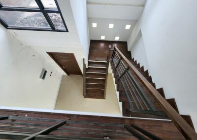 Staircase with wooden steps and metal railings