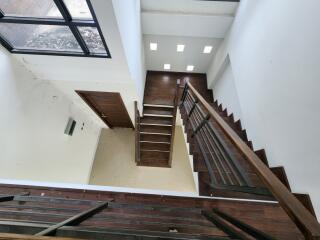 Staircase with wooden steps and metal railings