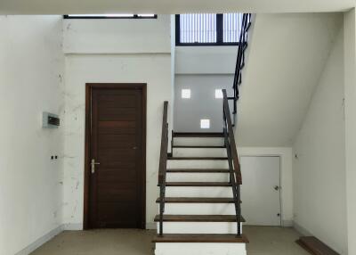 Well-lit interior space with staircase and white walls