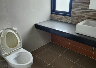 Modern bathroom with neutral tiles and natural light