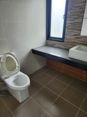 Modern bathroom with neutral tiles and natural light