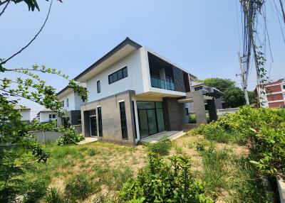 Modern two-story residential building with spacious lawn