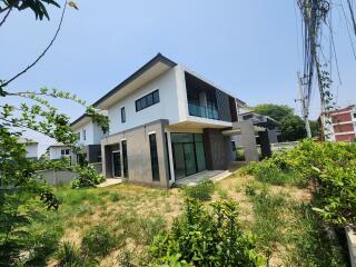 Modern two-story residential building with spacious lawn