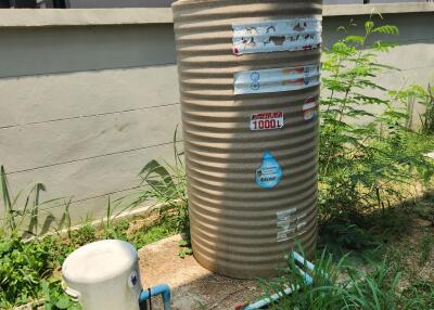 Large water tank with pipeline system in a backyard