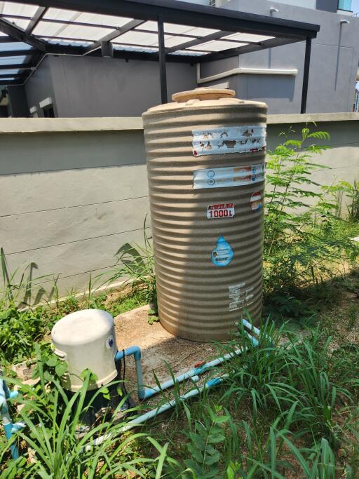 Large water tank with pipeline system in a backyard