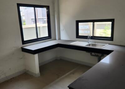 Unfinished kitchen interior with natural light