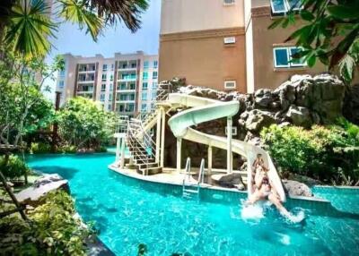 Luxurious pool with waterslide and tropical landscaping at a residential building
