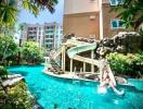 Luxurious pool with waterslide and tropical landscaping at a residential building