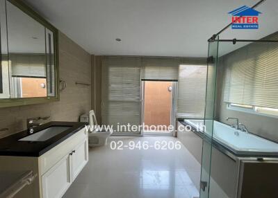 Modern bathroom with shower, bathtub, and dual vanity